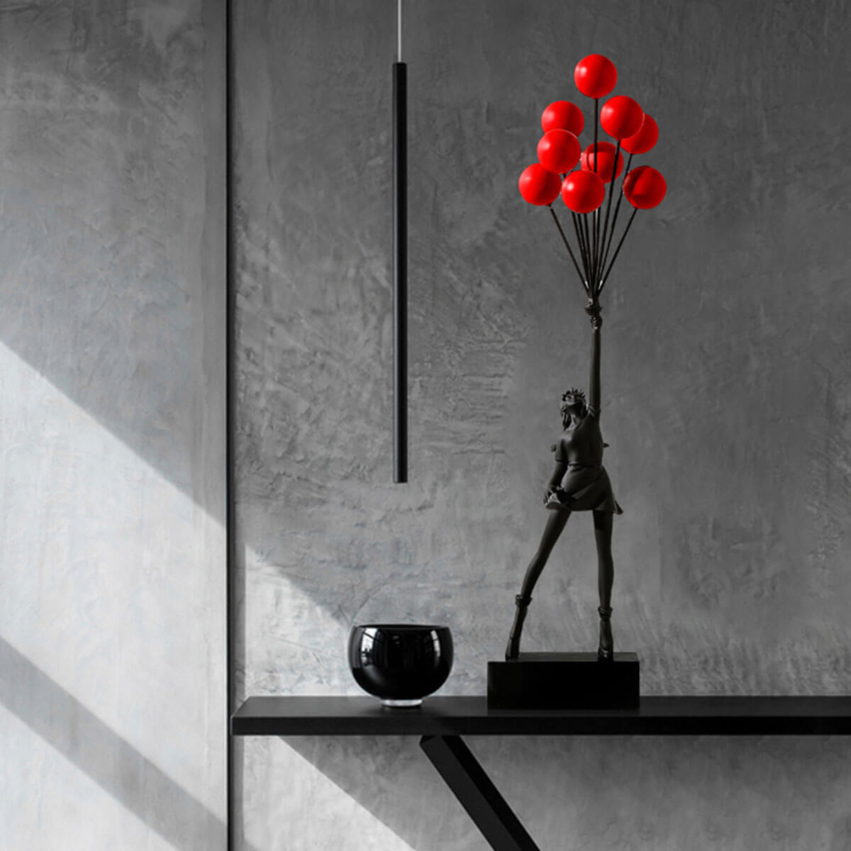 Black Flying Balloon Girl Banksy Statue with red balloons, modern art sculpture on minimalist shelf
