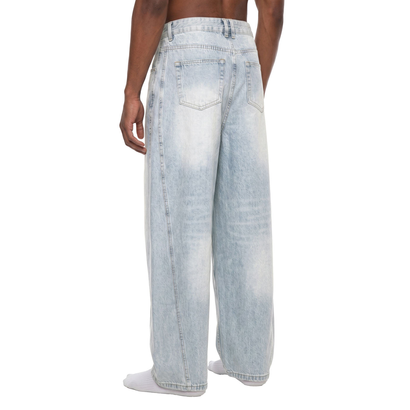 Back angle view of bleached baggy barrel jeans showing curved seam running from hip to hem
