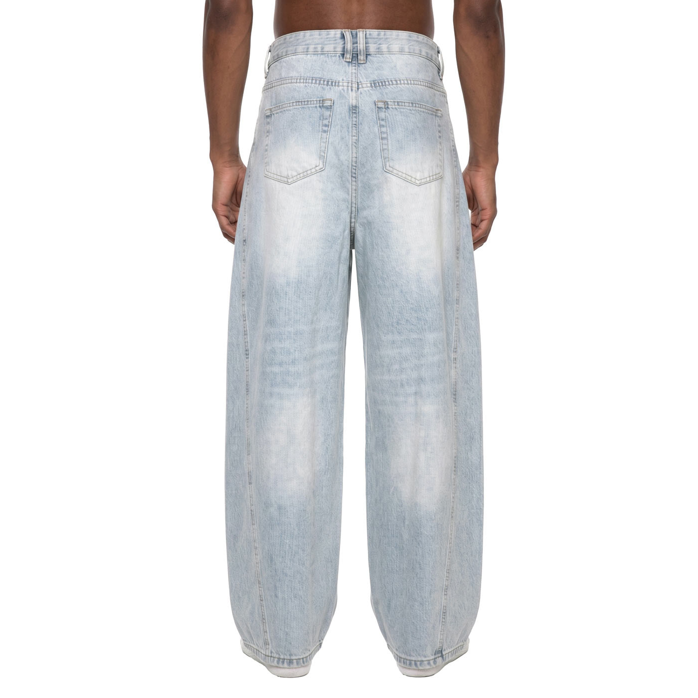 Back view of light wash baggy barrel jeans on model showing back pockets and sunfade