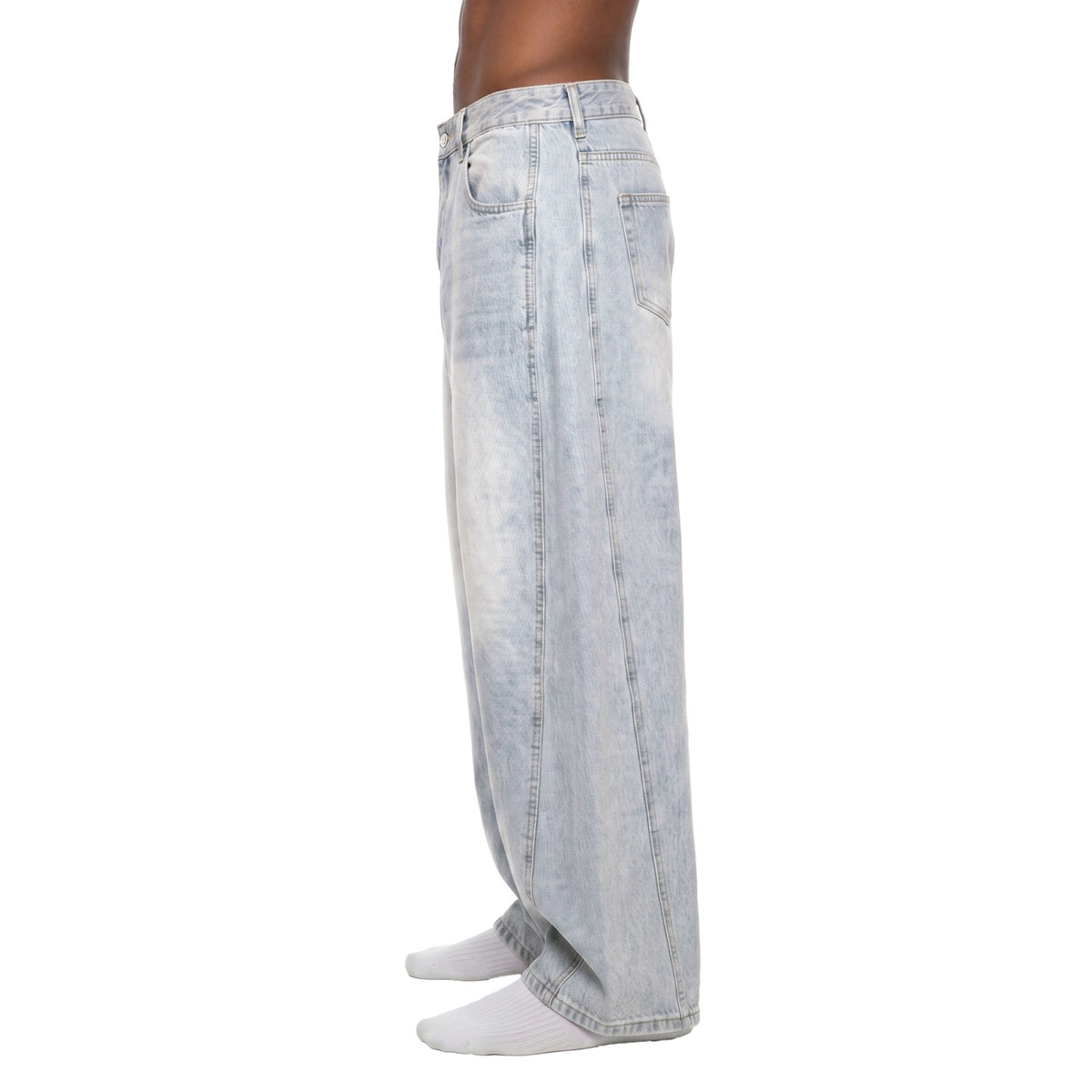 Side view of light wash barrel jeans showing curved side seam and rounded balloon silhouette