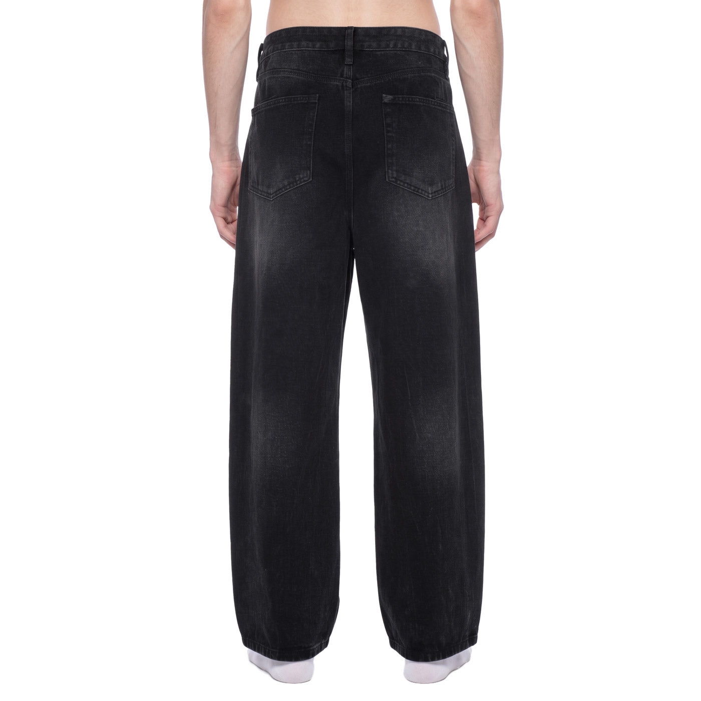Back view of black vintage wash wide leg jeans on model showing back patch pockets