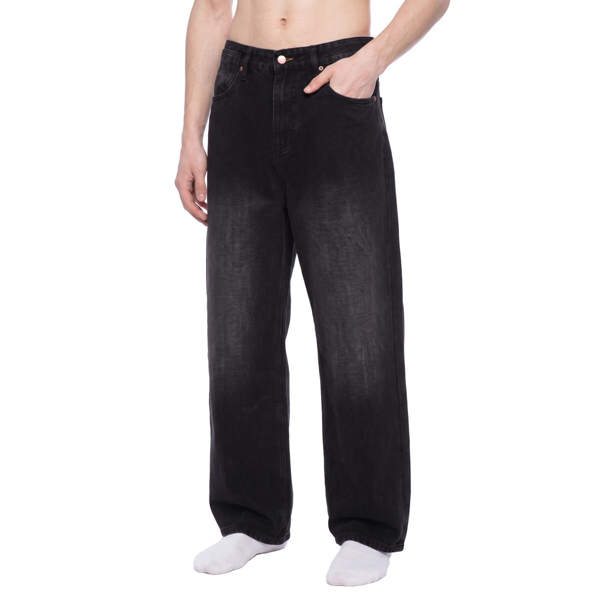 Black washed wide leg jeans, front angle view with hand in pocket showing relaxed baggy fit
