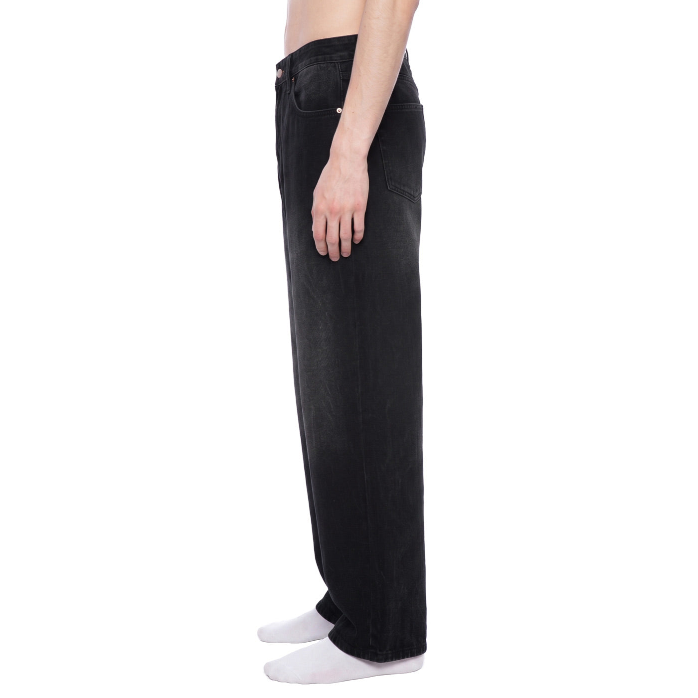 Side view of black baggy wide leg denim pants showing straight leg drape and mid-rise waist