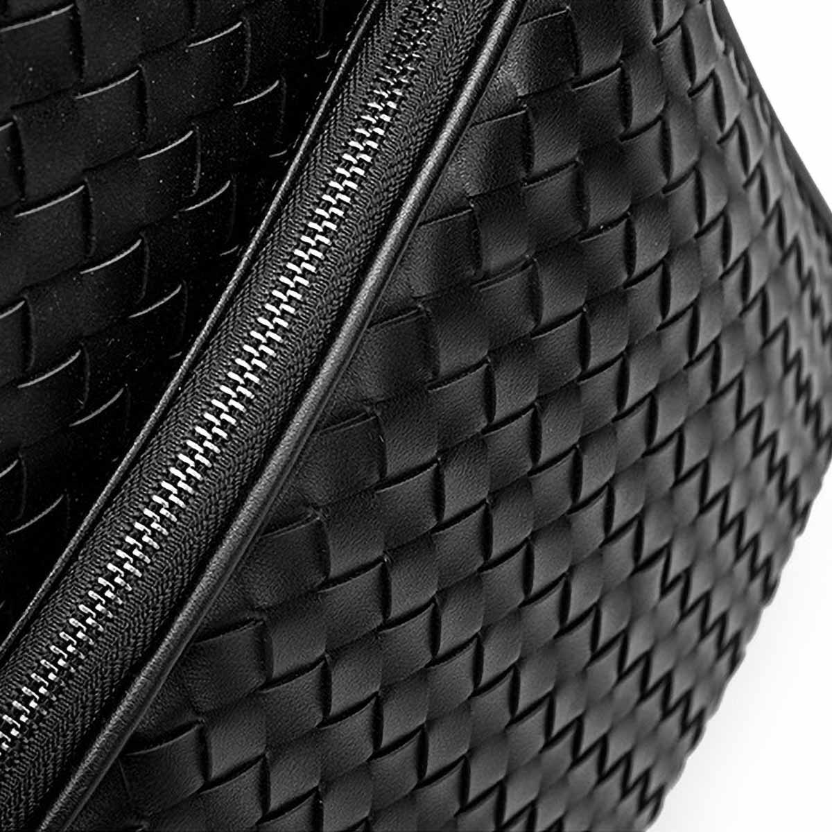 Close-up of durable woven PU leather texture on black backpack