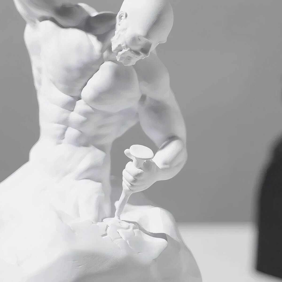 Detailed view of white bodybuilder muscle statue showing sculpted abdominal definition