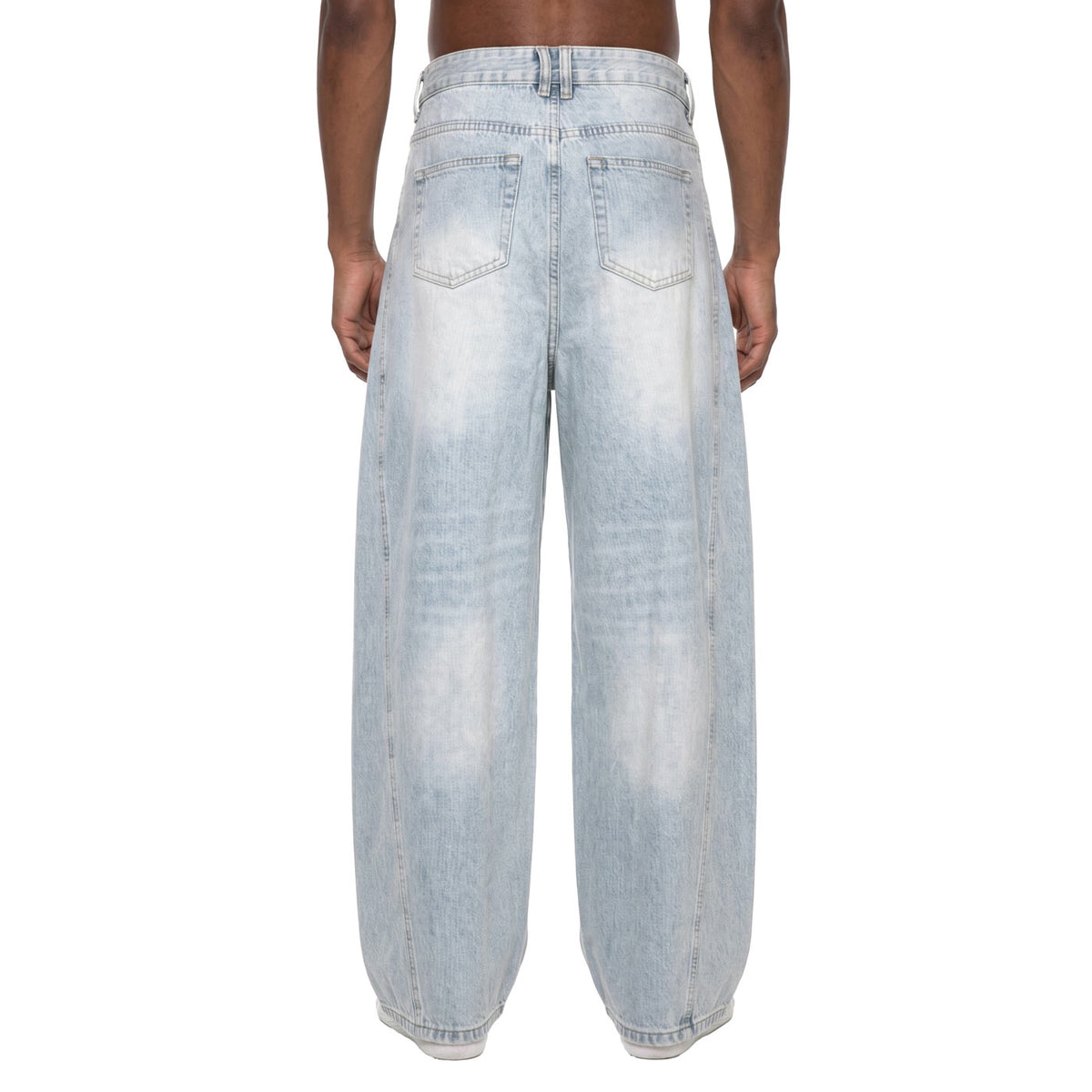 Back view of light wash baggy barrel jeans on model showing back pockets and sunfade