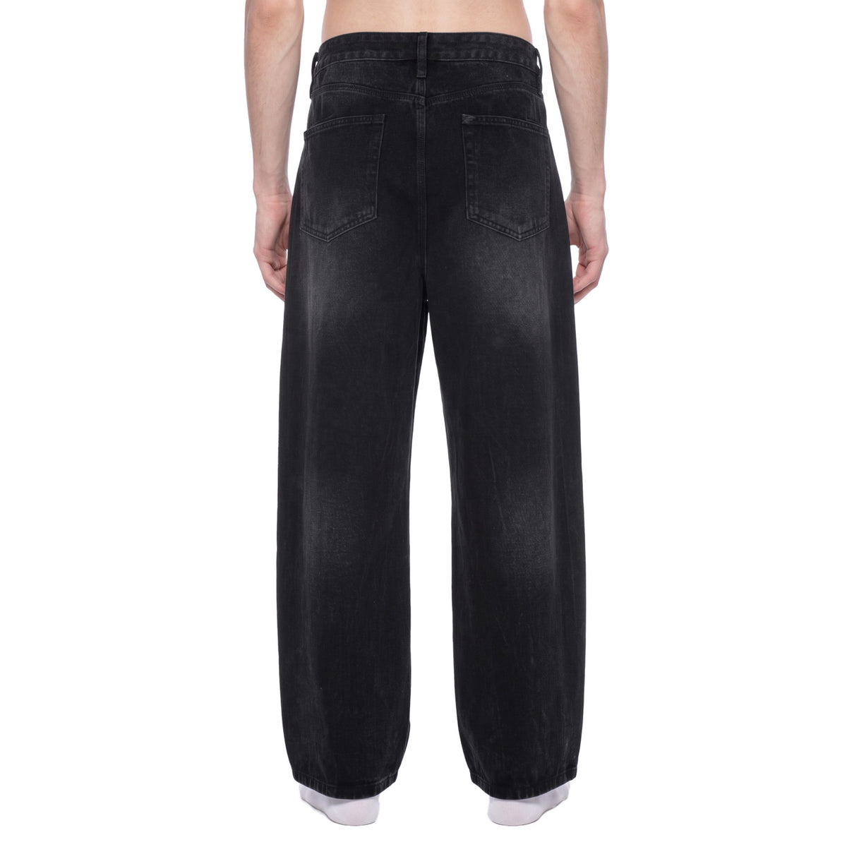Back view of black vintage wash wide leg jeans on model showing back patch pockets